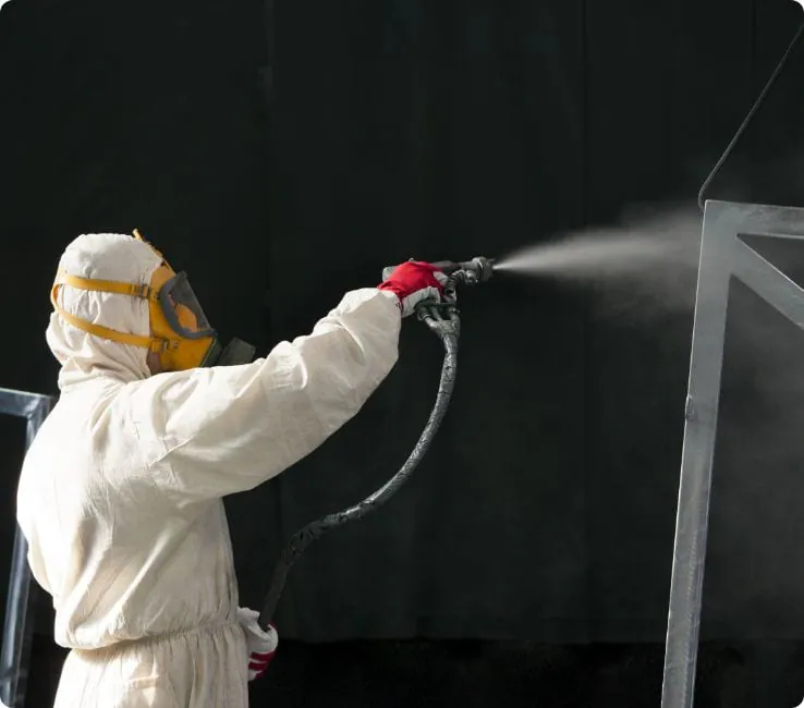 Technician spray-applying polyurea coating