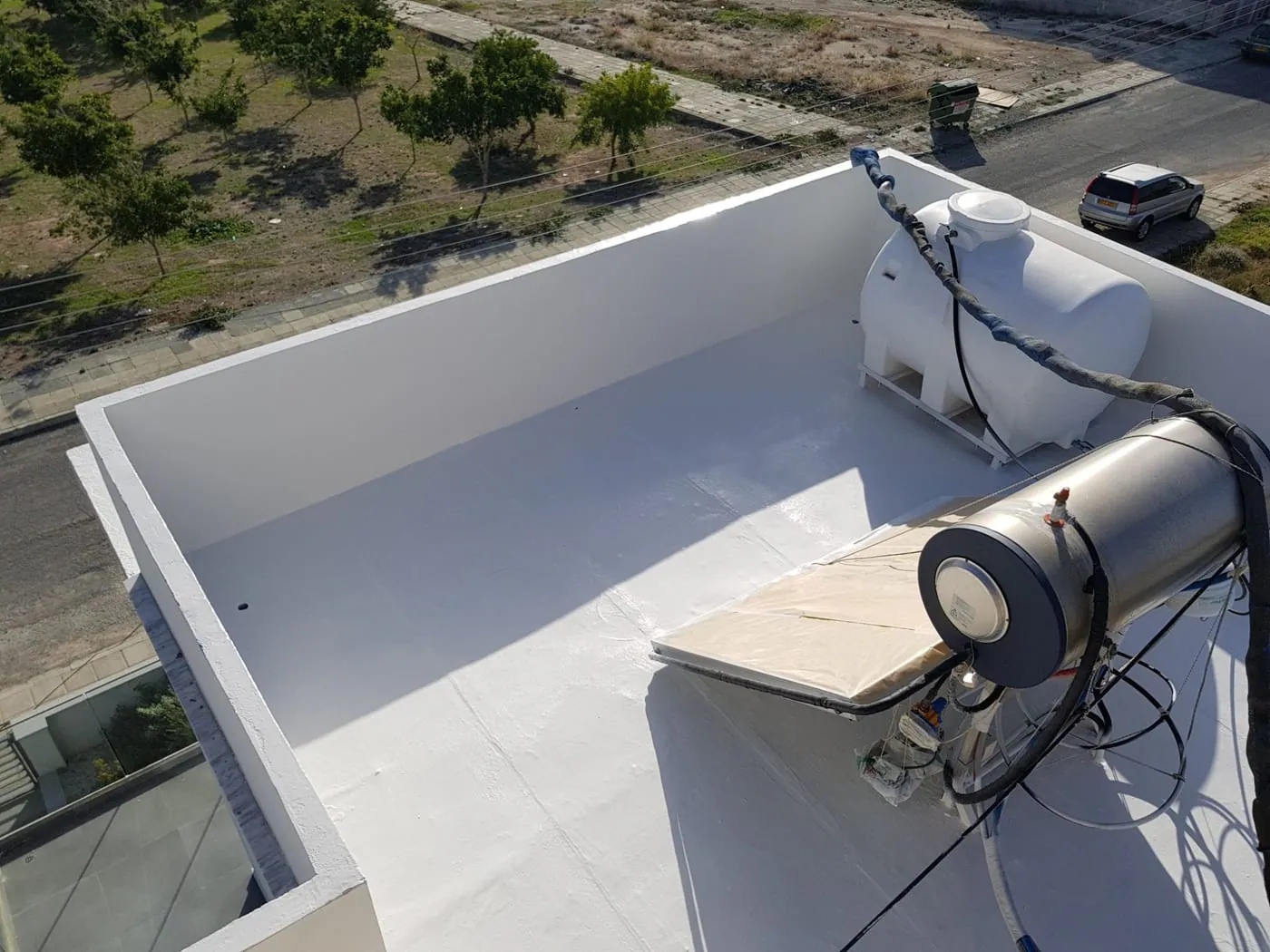 Rooftop sprayed with a seamless white polyurea waterproofing coating