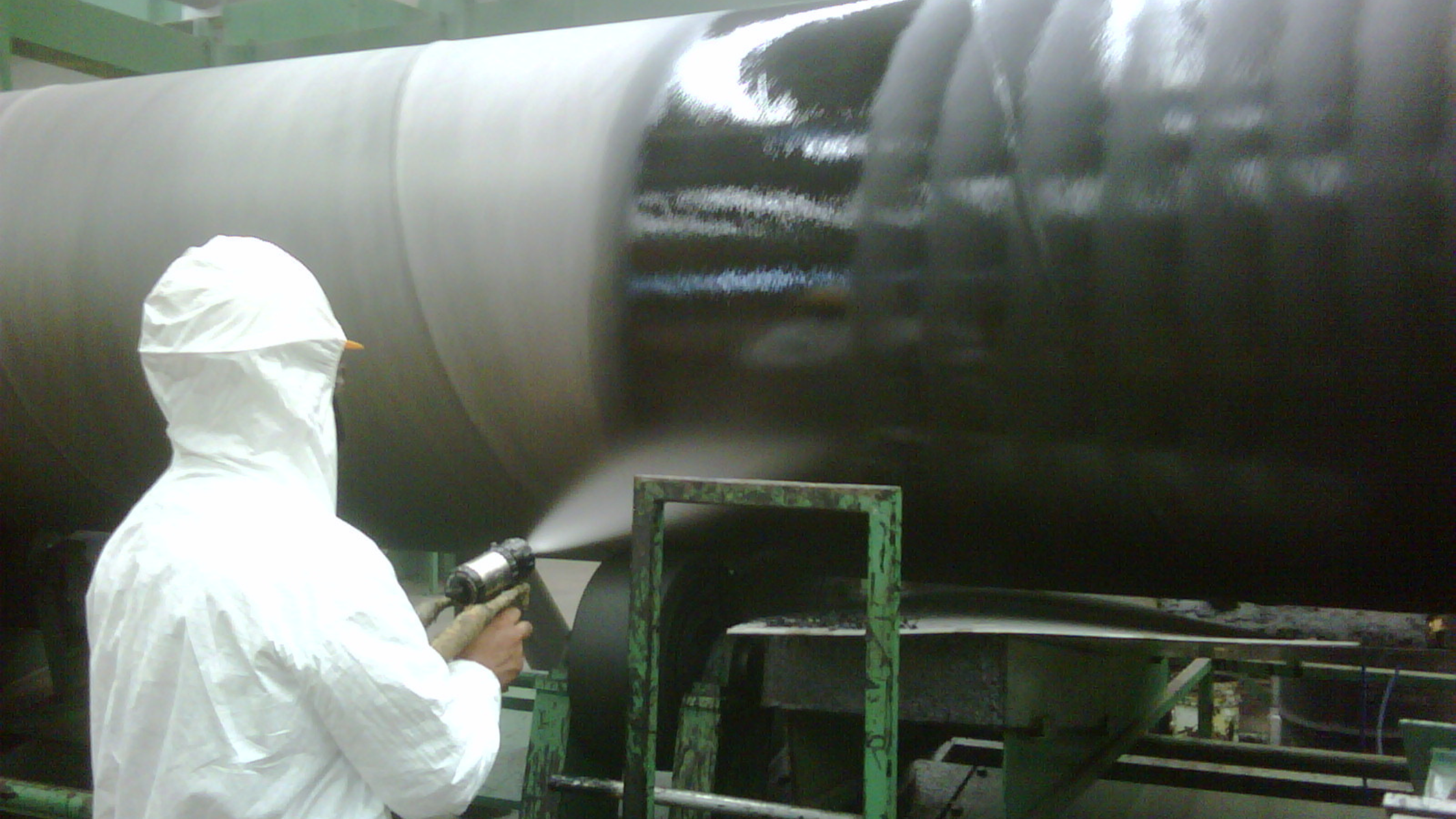 technician applying polyurea to factory components