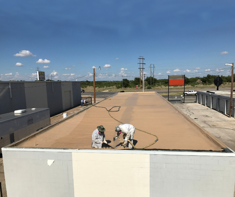 workers spraying polyurea on a roof